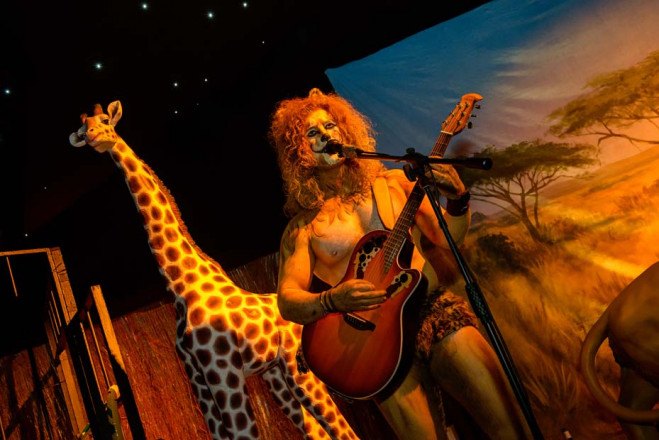 Lion guitarist in Africa themed party in marquee