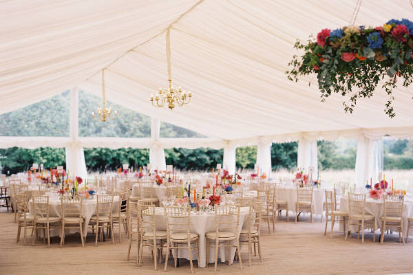 Luxury wedding marquee with matting, ivory lining, chandeliers and lime wash chairs