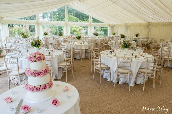 Wedding marquee with lime wash Camelot chairs, matting flooring
