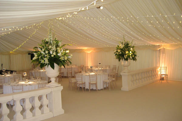 Uplighters provide soft lighting in wedding marquee