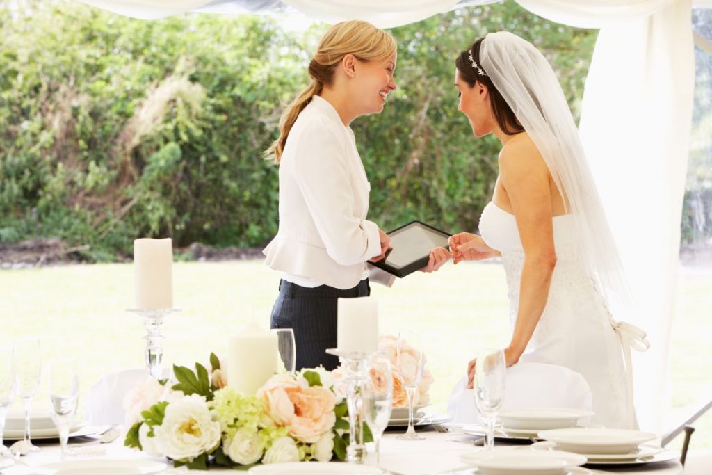 wedding planner with bride in marquee